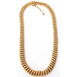French yellow metal necklace, a woven design of graduated plain polished and textured curb links,