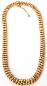 French yellow metal necklace, a woven design of graduated plain polished and textured curb links,
