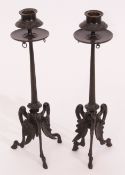 Pair of patinated bronze candlesticks, each with circular sconces, embossed with berries and foliage