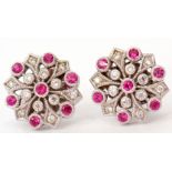 Pair of 18ct white gold and ruby diamond cluster earrings, the flowerhead design features seven