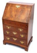 18th century style walnut bureau of small proportions, the cross banded top and fall front enclosing