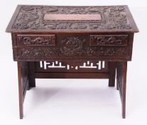 Oriental hardwood centre table, the top ornately carved with dragons, bats and hieroglyphics