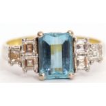Aquamarine and diamond ring, the emerald cut aquamarine in a four claw setting between six square
