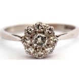 Precious metal and diamond cluster ring, the principal diamond 0.20ct approx surrounded by eight