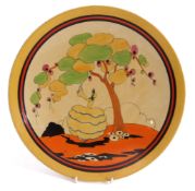 Clarice Cliff plate in the Idyll type pattern with a lady in flounced skirt below balloon like