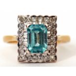 Aquamarine and diamond cluster ring, the rectangular shaped aquamarine claw set and raised within