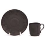 18th century Wedgwood black basalt coffee cup and saucer decorated in relief with classical