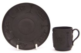 18th century Wedgwood black basalt coffee cup and saucer decorated in relief with classical