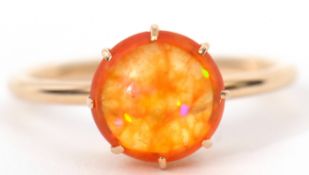 Fire opal ring, the circular cabochon fire opal multi-claw set and raised in a plain polished