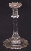 18th century cut glass taper stick, possibly Waterford, the serrated sconce above a faceted type