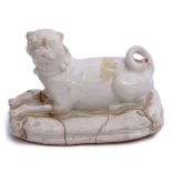 Bow porcelain figure of a pug seated on a cushioned base with tassels to corner (cracks), 12cm long