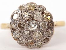 Diamond cluster ring, the circular panel set with 19 mixed cut diamonds, all in a basket setting,