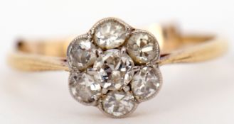 Precious metal diamond cluster ring, the principal diamond 0.15ct app, raised within a surround of