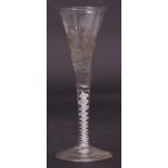 Mid-18th century wine flute, the trumpet bowl engraved with flowers and an insect above an air twist