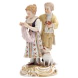 Late 19th century Meissen group of a boy and a girl on a gilt scroll base with dog by their side,