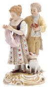 Late 19th century Meissen group of a boy and a girl on a gilt scroll base with dog by their side,