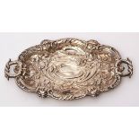 Late Victorian small dressing table tray of shaped oval design with serpent formed handle,