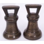 Two early 19th century bronze bell shaped 14lb weights, each 19cm high