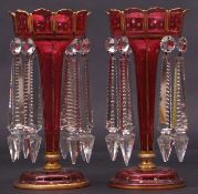 Pair of ruby coloured glass table lustres with typical gilded rim and gilded star decoration to