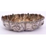 Victorian small shaped circular table dish with gilt interior, heavily embossed and chased with