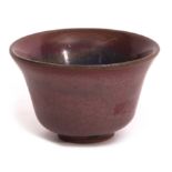 Chinese pottery bowl with everted rim and high fired rouge flambe type glaze, 8cm diam