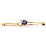 Antique diamond and sapphire set cross over bar brooch, with a brilliant cut diamond opposite a blue