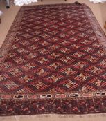 Early 20th century Yomut carpet decorated with the Dyrnak Guls design, the central panel with