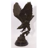 After Moignez, Green patinated cast metal study of an eagle with outstretched wings perched on an
