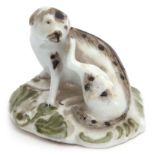18th century English porcelain model of a dog seated on a flat base, the base picked out with