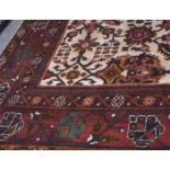 20th century large Indian carpet, a central panel of geometric floral decoration within a multi-gull