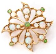 Opal and green garnet brooch of circular open work design set with various graduated opals and green