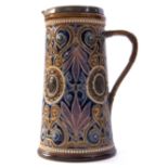 Doulton Lambeth lemonade jug with an incised design in blue and brown with medallions of classical