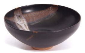 Unusual Oriental pottery bowl with a Tenmoku type glaze and streaked design to interior, 15cm diam