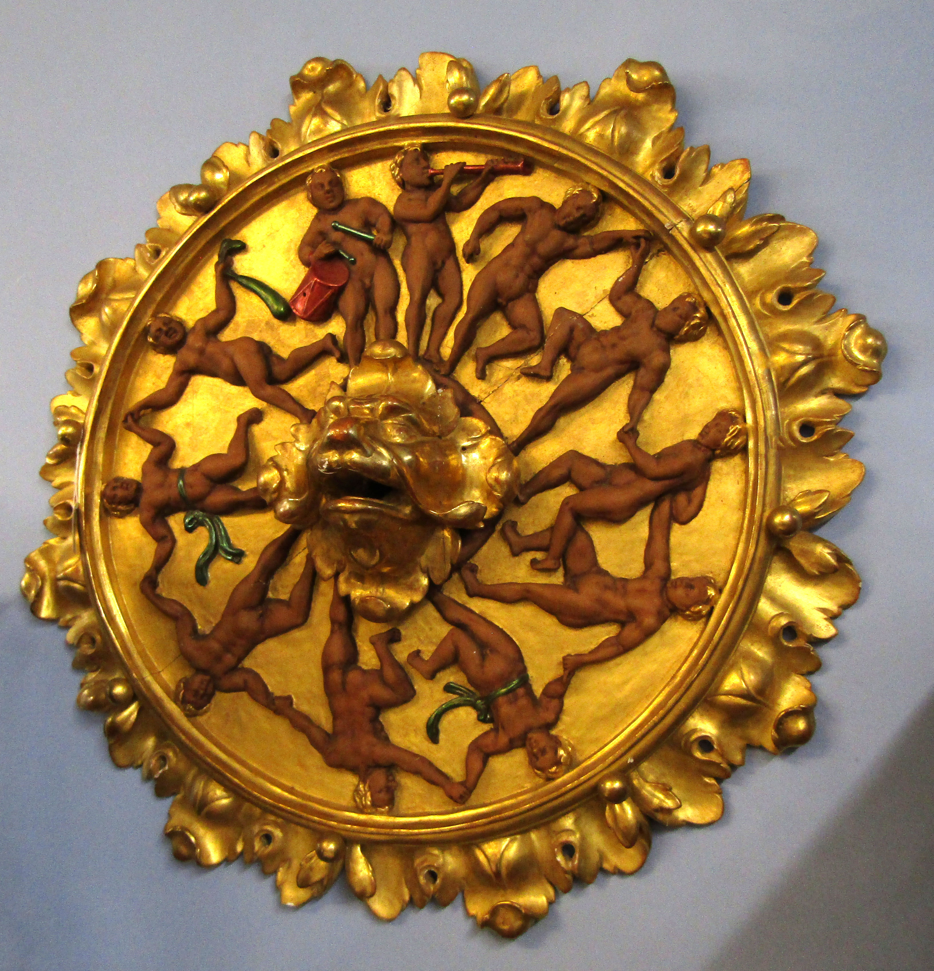Ornate gilt wood and gesso ceiling boss with foliate and ball moulded surround, central griffon mask