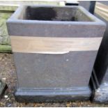 Black painted composition garden planter of square form with a stepped base, 35cm high