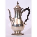 Edwardian coffee pot of baluster form in Queen Anne style, having bud finial to a domed and hinged