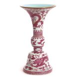 Chinese porcelain Gu shaped vase, decorated in pink enamel en camaieau with a two-horned five claw