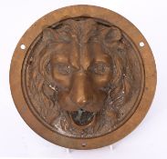 Unusual cast bronze mount, A Pandiani, Milano, of circular form in the form of a lion mask, 23cm
