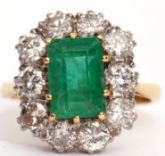 Emerald and diamond cluster ring, the step cut emerald set within a brilliant cut diamond