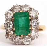 Emerald and diamond cluster ring, the step cut emerald set within a brilliant cut diamond