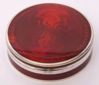 Red guilloche circular lidded powder box, the hinged lid opening to reveal a mirror under, gilt