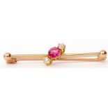 Victorian yellow gold, ruby and diamond bar brooch, the circular cut faceted ruby flanked by two