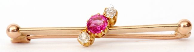 Victorian yellow gold, ruby and diamond bar brooch, the circular cut faceted ruby flanked by two