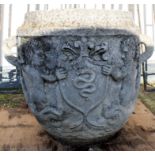Large composition two-handled garden urn with armorial type decoration, 68cm high