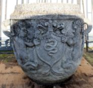 Large composition two-handled garden urn with armorial type decoration, 68cm high