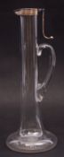 An unusual late Victorian plain glass claret jug of narrow baluster form with star cut base,