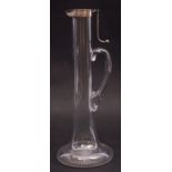 An unusual late Victorian plain glass claret jug of narrow baluster form with star cut base,