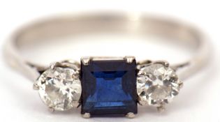 Precious metal sapphire and diamond three stone ring, the square cut sapphire flanked between two