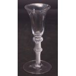 Mid-18th century double knopped wine glass, the bell bowl above a multi-spiral air twist knopped