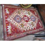 Good quality modern Caucasian wool carpet, the centre with three interlinked lozenges, the corners